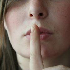 Woman with her finger to her lips
