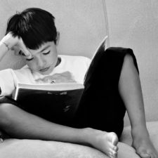 Boy sitting on a sofa, reading