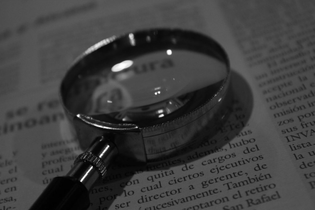 Magnifying glass resting on a book