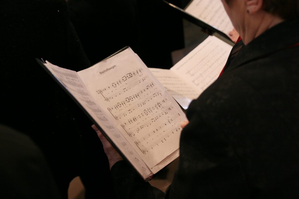 Singer holding a folder of choral music