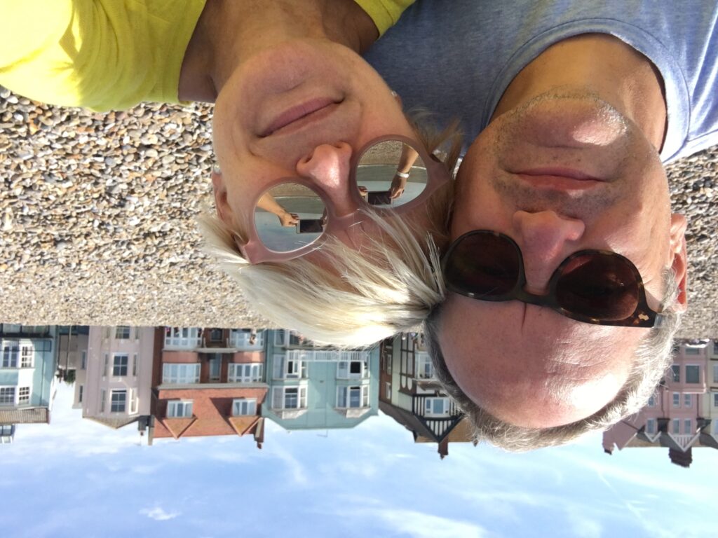 Chris Gillett and Lucy Schaufer sitting on Aldeburgh Beach